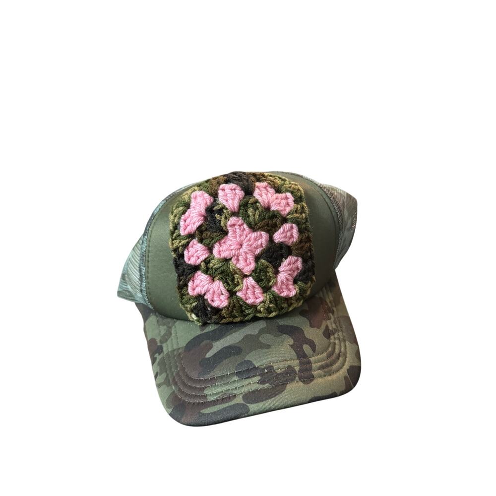 Trucker hat with pink crochet patch. Cap is green camo. Adjustable back .